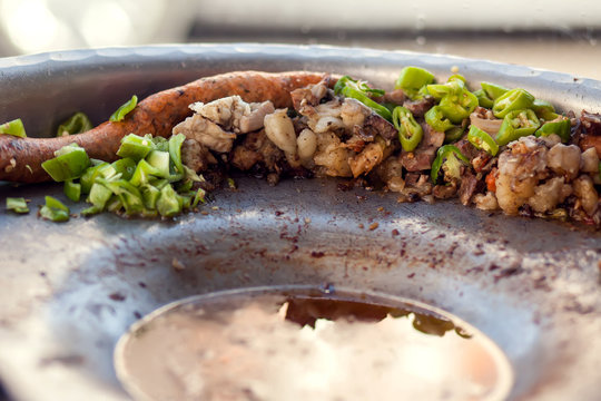 Rice-stuffed sausages called Mombar and vegetables on the plate