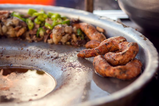 Rice-stuffed sausages called Mombar and vegetables on the plate