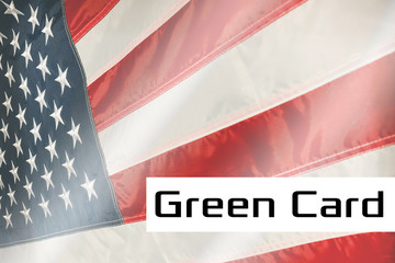 Green Card on a USA flag background. United States of America flag waving in the wind. Proud American Flag Waving,. American Green Card concept