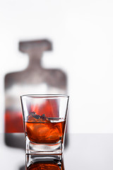 glass with alcohol drink and bottle