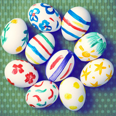 Painted Easter eggs on a green background with white polka dots. Toned image. Beautiful holiday card. Space for text. Happy easter.