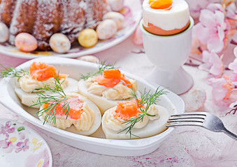 Easter breakfast.Cake and eggs with salmon