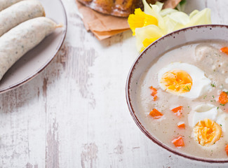 Easter breakfast. Sour rye soup with eggs and sausage