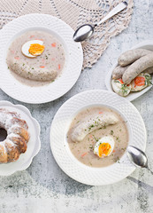 Easter breakfast. Sour rye soup with eggs and sausage
