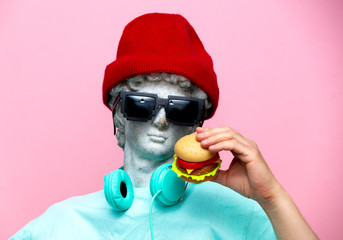 Antique bust of male in hat and sunglasses with hamburger