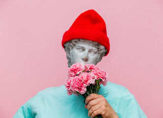 Antique bust of male in hat with carnations bouquet