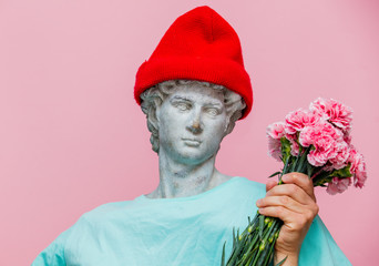 Antique bust of male in hat with carnations bouquet