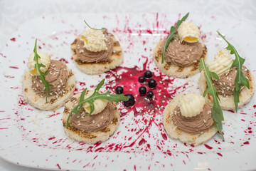 Toast with pate, snack on a plate and light background, copy space.