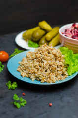 Russian buckwheat porridge near greens, proper nutrition, vegetarian