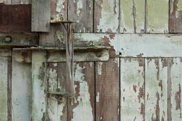 Old wooden handle on a wooden wall