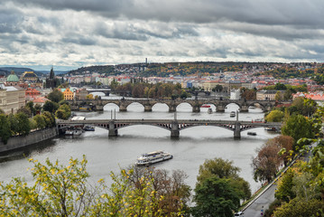 Fototapeta na wymiar Gorgeous view on Prague city center, Vltava river and cascade of bridges, Czech Republic. Autumn Prague.