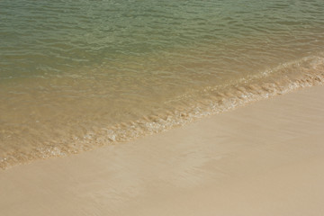 Soft wave of blue ocean on sandy beach. Background