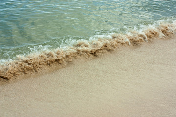 Soft wave of blue ocean on sandy beach. Background
