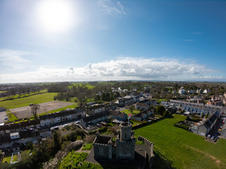 Fototapeta na wymiar aerial view of buildings, houses on Coast of Irish Sea against clear blue sky. Castle on hill in Donaghadee, Northern Ireland