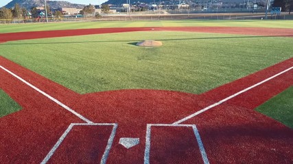 CASTLE ROCK, COLORADO/USA - MARCH 28 2019: Aerial drone video in the early morning of a freshly prepared local park baseball field ready for baseball opening day play. - Powered by Adobe