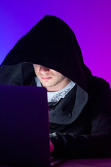 Closeup photo handsome man working on laptop anonymously