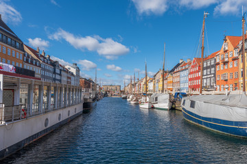 Fototapeta na wymiar Nyhavn Canal under a blue sky with some clouds