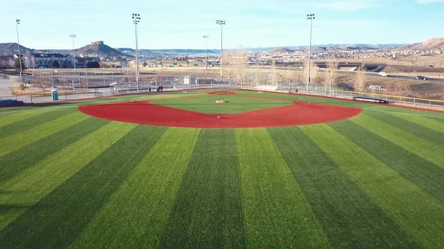 CASTLE ROCK, COLORADO/USA - MARCH 28 2019: Aerial drone video in the early morning of a freshly prepared local park baseball field ready for baseball opening day play.