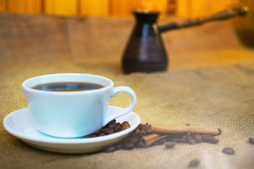 White cup of coffee and turkish pot.