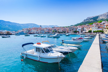 Wonderful romantic summer afternoon landscape panorama coastline Adriatic sea. Boats and yachts in harbor at cristal clear turquoise water. Baska on the island of Krk. Croatia. Europe.