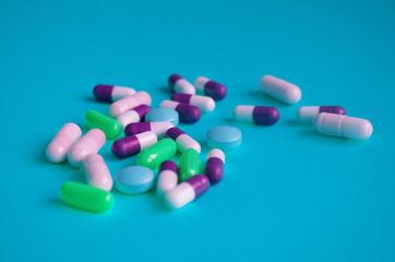 Color pills on blue background. Pharmaceutical medicine concept.