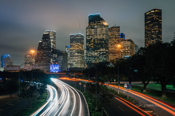 Fototapeta na wymiar Long exposure of traffic on Allen Parkway and the Houston skyline at night, in Houston, Texas