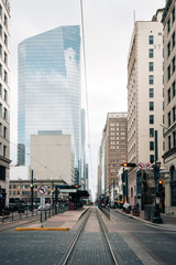 Light rail tracks and modern buildings on Main Street in downtown Houston, Texas