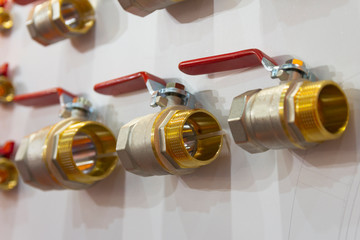 Red metal ball valves in store. Sale