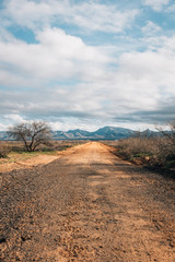Dirt road and mountains in the desert of eastern Arizona