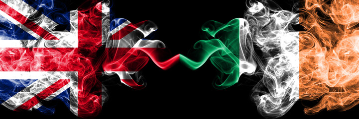 United Kingdom vs Ireland, Irish smoky mystic flags placed side by side. Thick colored silky smoke flags of Great Britain and Ireland, Irish.