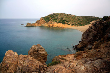 Fototapeta na wymiar Cliff overlooking an isle with some trees, Vai beach of Crete Island