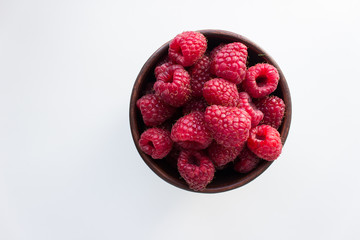  fresh raspberries in a bowl isolated on white