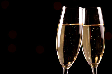 Champagne glasses on black background. Holiday celebration concept.