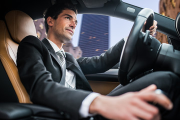 Man driving car in a city