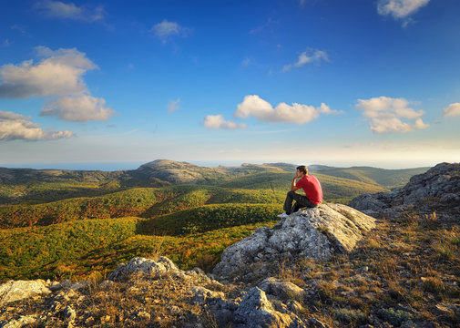 Man on top of mountain.