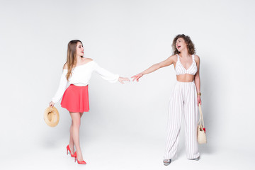 Friendsip! Beautifu woman walk together, while staying on white background!