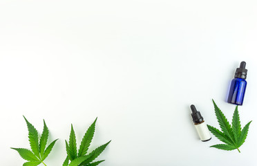 Marijuana leafs and cannabis oil bottles isolated On white