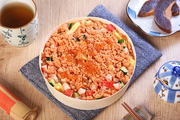 Chirashi sushi bowl with salmon, cucumber, salmon roe and sweet omelette, Japanese Food.