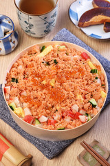 Chirashi sushi bowl with salmon, cucumber, salmon roe and sweet omelette, Japanese Food.