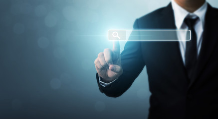 Searching information data on internet networking concept. Hand of businessman touching magnifying glass icon search