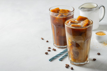 Two glasses of cold coffee on white background.