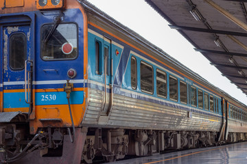 Train at train station waiting for people to transport.