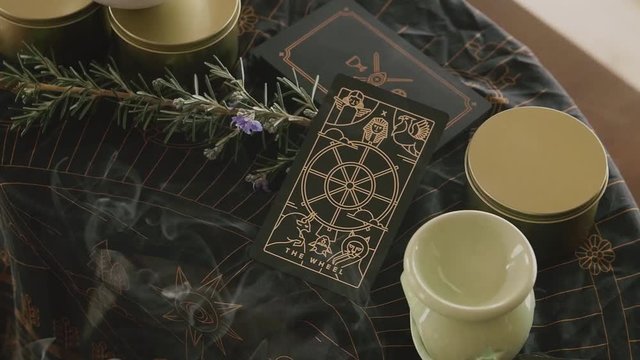 Pan across psychic medium altar table placing tarot card