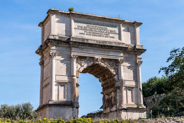 Fototapeta na wymiar Arch of Titus - A closeup view of west side of the 1st-century triumphal arch in Roman Forum. Rome, Italy. Latin inscription added in 19th-century to record restoration ordered by Pope Pius VII. 