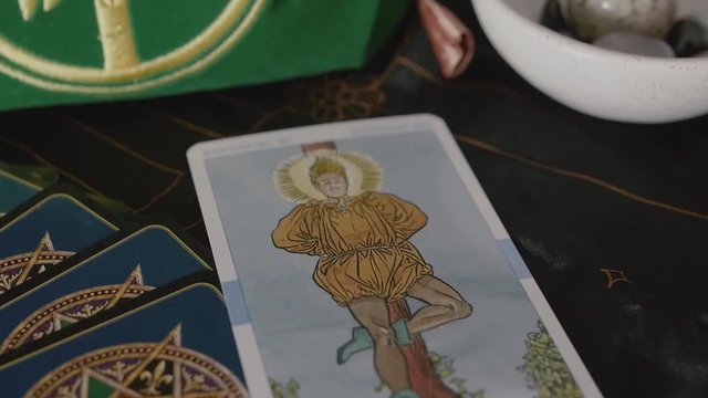 Slow zoom into tarot card on clairvoyant table