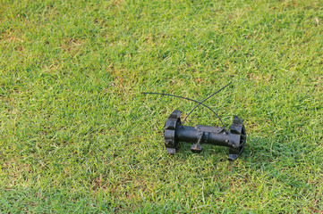 Bomb detection robot on green grass field.
