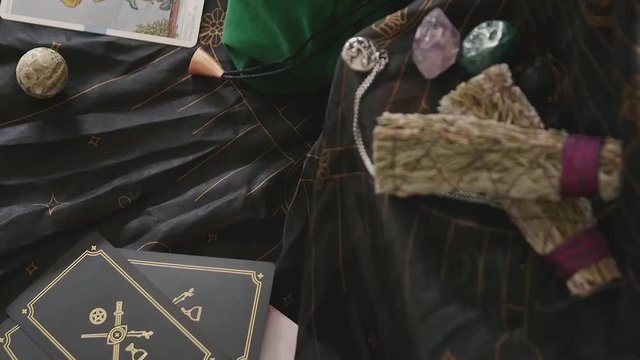 Slow zoom out placing a bowl of crystals on an altar