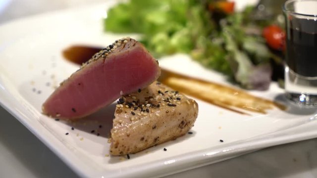 plate of tuna staek with salad