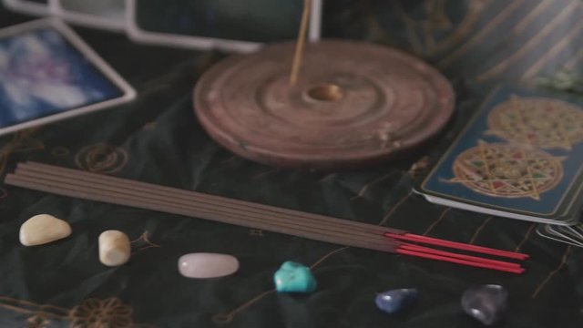 Slow pan across Tarot cards and crystals