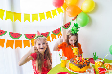 Two girls celebrate their birthday. Fruit Party. Pineapple and watermelon costume. Children's holiday.